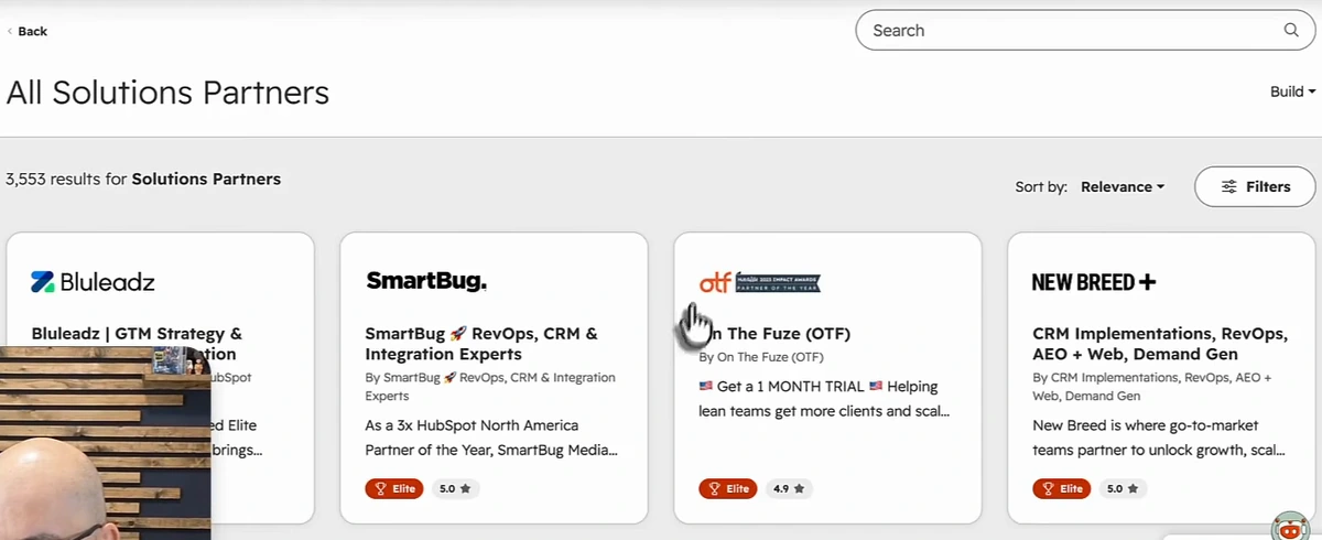 HubSpot Marketplace, All Solutions Partners, 3,553 results for Solutions Partners, sorted by relevance, with partner cards for Bluleadz, SmartBug, On The Fuze and New Breed, each showing an Elite badge and a 5.0 or 4.9 rating